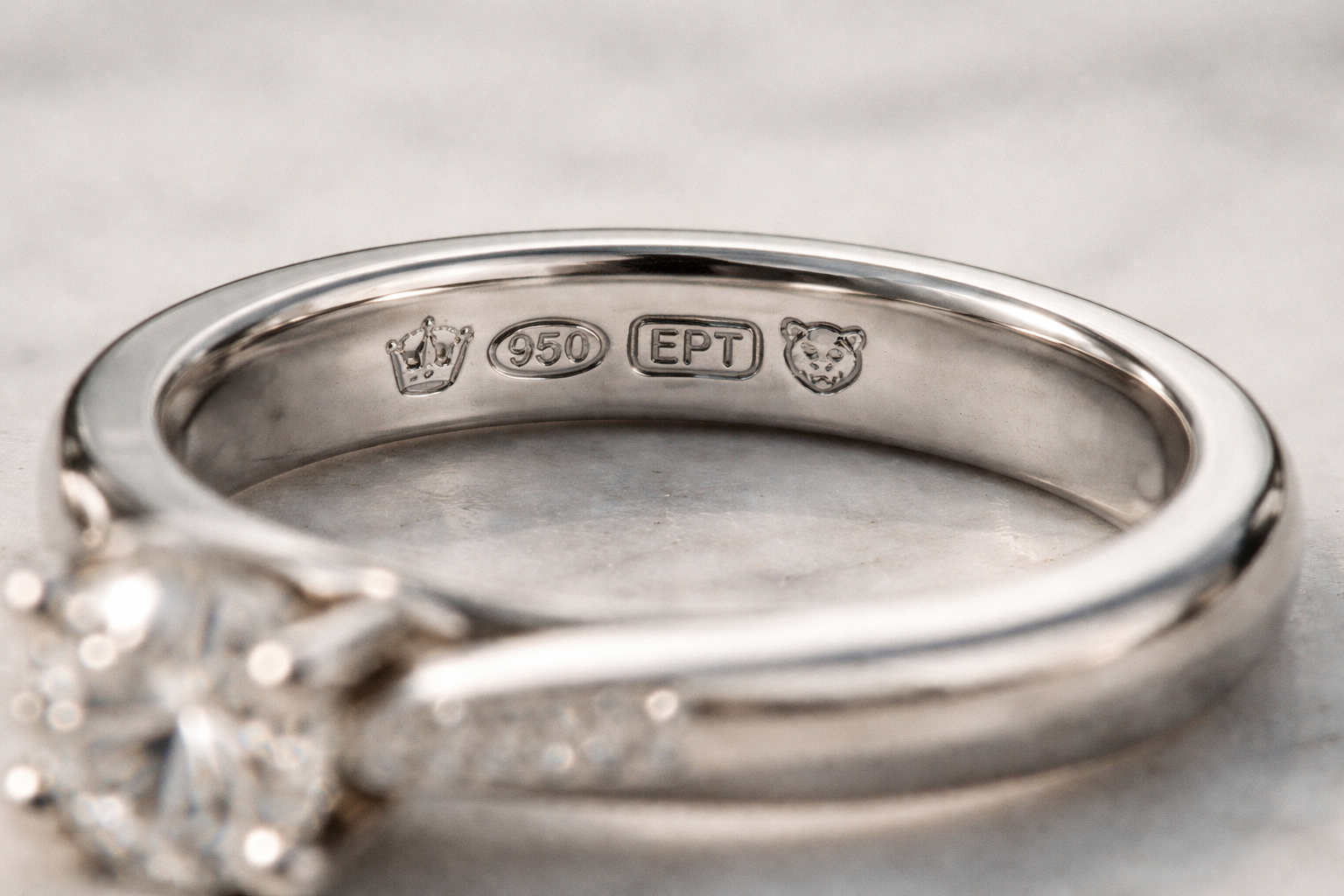 Close-up macro of a platinum ring shank showing UK Pt950 hallmarks